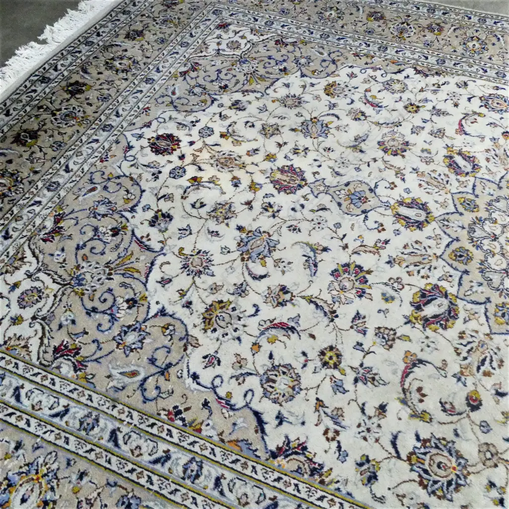 A Persian hand knotted carpet, curvilinear flowering tendril design in pale tones. One lighter area and minor signs of wear. 3500 x 2550mm. Image 1++