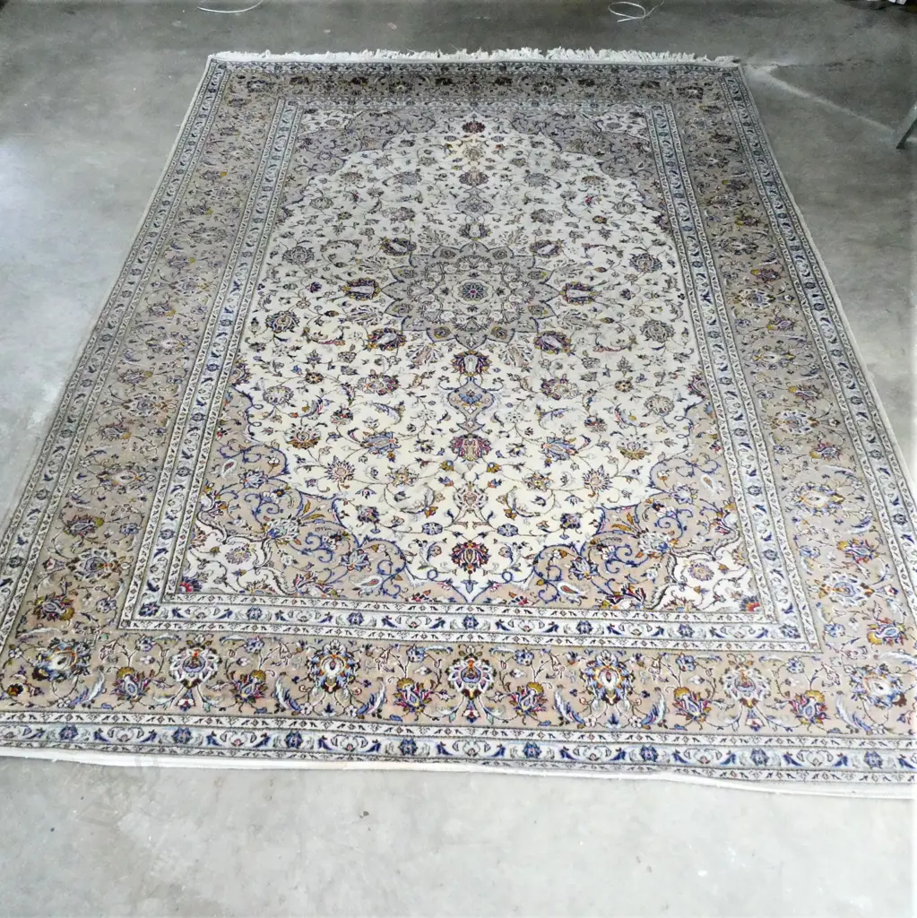 A Persian hand knotted carpet, curvilinear flowering tendril design in pale tones. One lighter area and minor signs of wear. 3500 x 2550mm. Image 1++