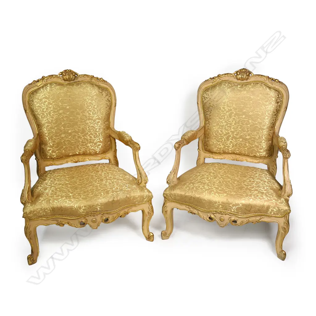 A pair of antique 20thC French style bergère armchairs, carved and painted frames with silken pale gold upholstery patterned with scrolling tendrils. 760 x 620 x 1300mm. Image 1++