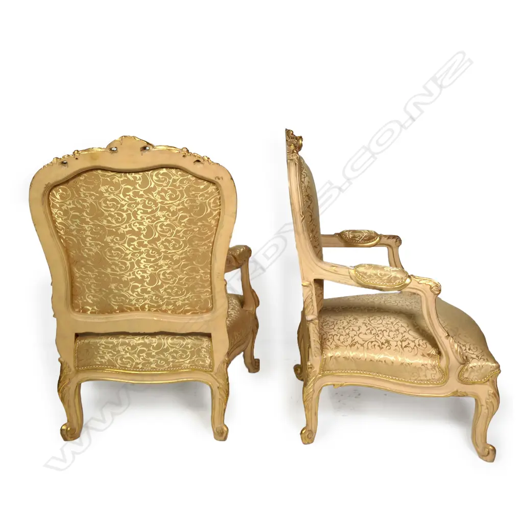 A pair of antique 20thC French style bergère armchairs, carved and painted frames with silken pale gold upholstery patterned with scrolling tendrils. 760 x 620 x 1300mm. Image 1++