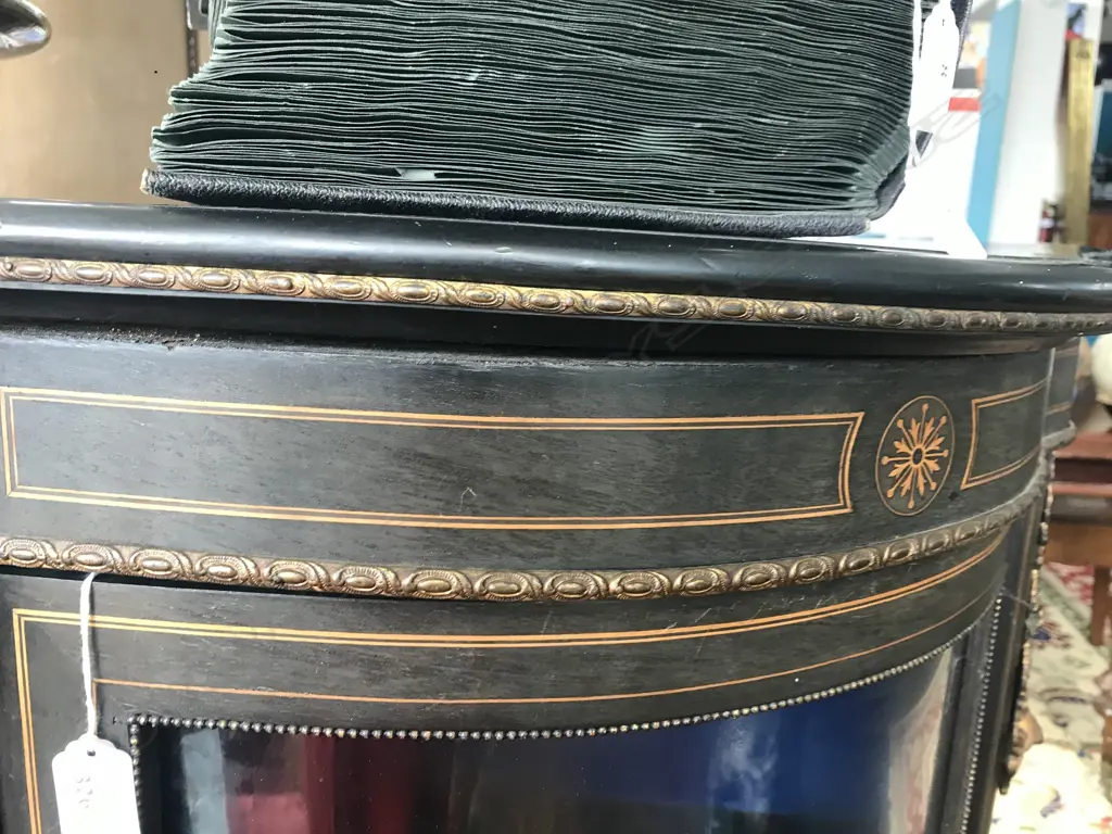 A Victorian ebonised credenza, decorative stringing with ormolu embellishments, shaped doors to the sides, the front with a Sevres style plaque to the centre, raised on plinth base and squat bun feet. 1680 x 420 x 1080mm. Image 1++