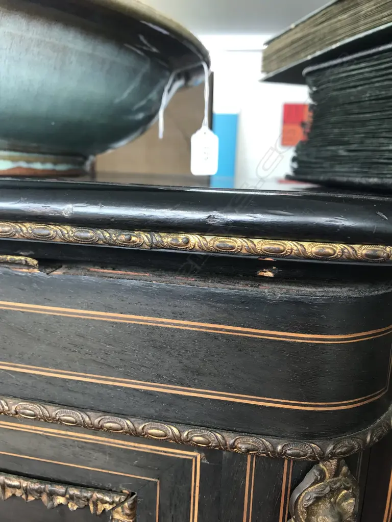 A Victorian ebonised credenza, decorative stringing with ormolu embellishments, shaped doors to the sides, the front with a Sevres style plaque to the centre, raised on plinth base and squat bun feet. 1680 x 420 x 1080mm. Image 1++