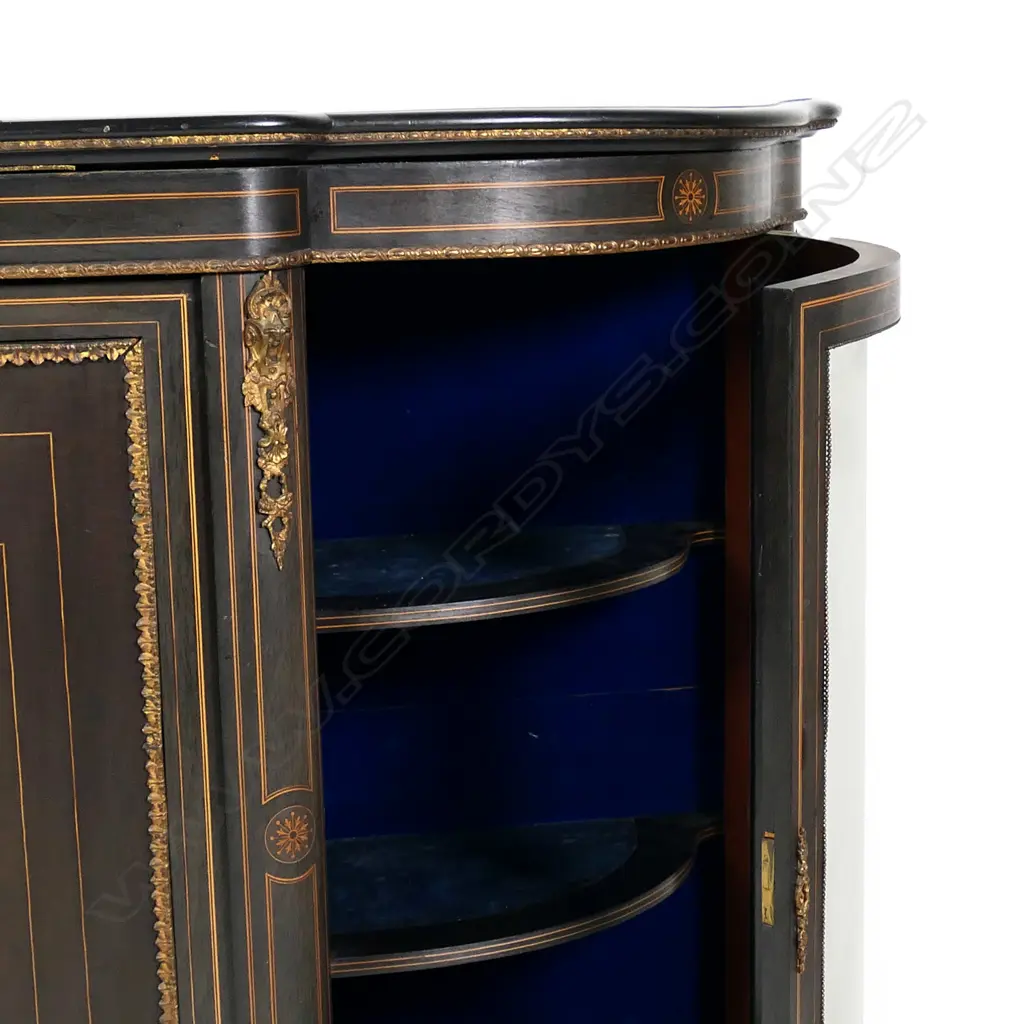 A Victorian ebonised credenza, decorative stringing with ormolu embellishments, shaped doors to the sides, the front with a Sevres style plaque to the centre, raised on plinth base and squat bun feet. 1680 x 420 x 1080mm. Image 1++