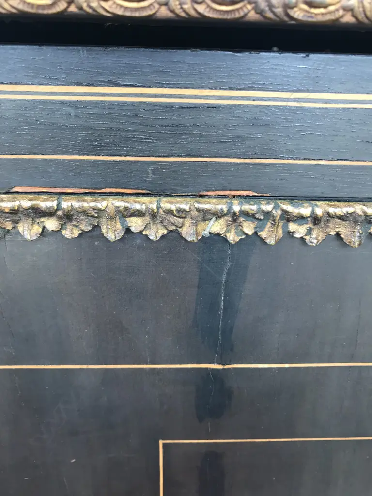 A Victorian ebonised credenza, decorative stringing with ormolu embellishments, shaped doors to the sides, the front with a Sevres style plaque to the centre, raised on plinth base and squat bun feet. 1680 x 420 x 1080mm. Image 1++