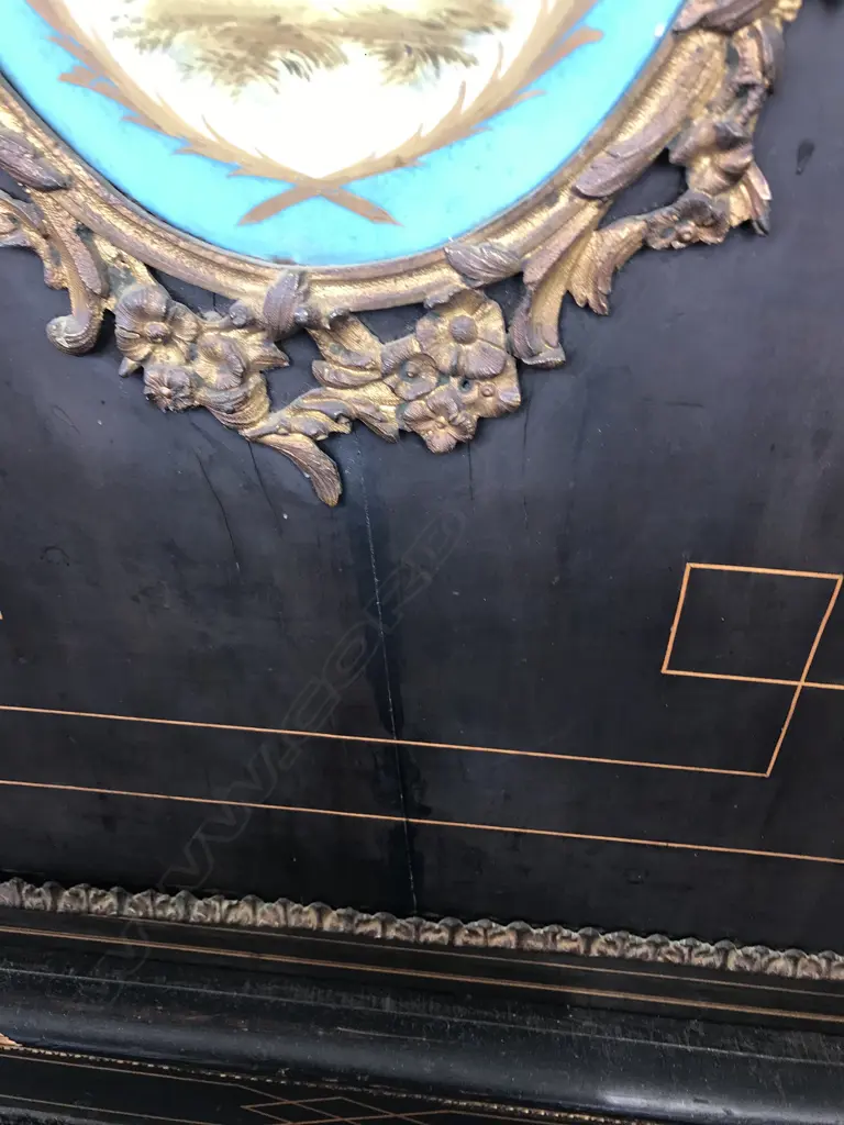 A Victorian ebonised credenza, decorative stringing with ormolu embellishments, shaped doors to the sides, the front with a Sevres style plaque to the centre, raised on plinth base and squat bun feet. 1680 x 420 x 1080mm. Image 1++