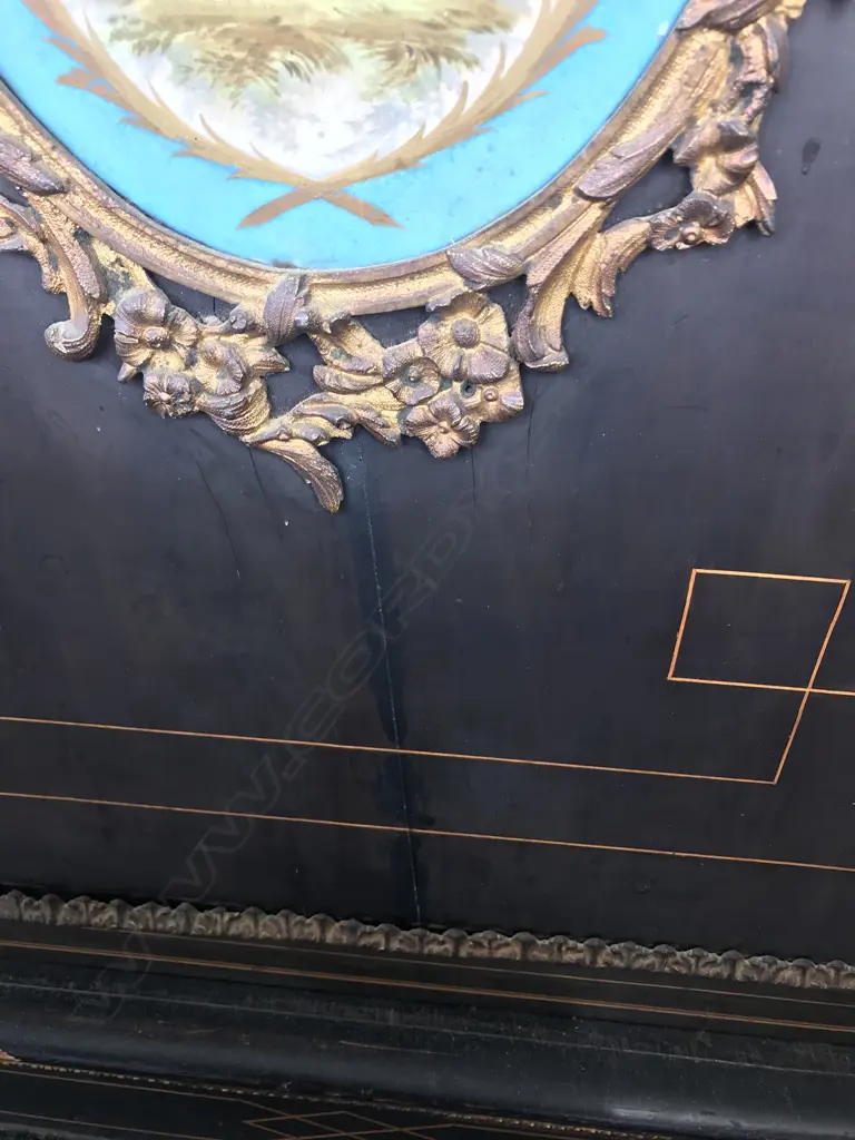 A Victorian ebonised credenza, decorative stringing with ormolu embellishments, shaped doors to the sides, the front with a Sevres style plaque to the centre, raised on plinth base and squat bun feet. 1680 x 420 x 1080mm. Image 1++