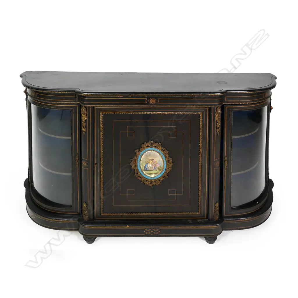 A Victorian ebonised credenza, decorative stringing with ormolu embellishments, shaped doors to the sides, the front with a Sevres style plaque to the centre, raised on plinth base and squat bun feet. 1680 x 420 x 1080mm. Image 1++