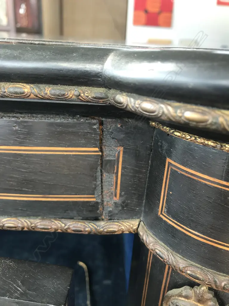 A Victorian ebonised credenza, decorative stringing with ormolu embellishments, shaped doors to the sides, the front with a Sevres style plaque to the centre, raised on plinth base and squat bun feet. 1680 x 420 x 1080mm. Image 1++