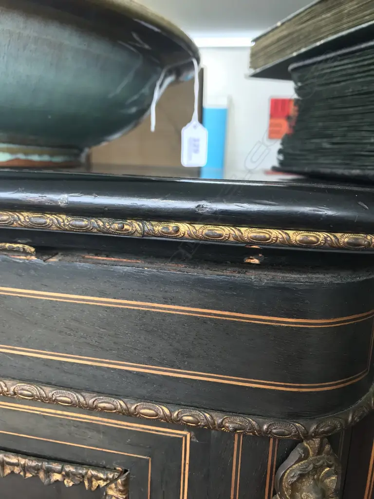 A Victorian ebonised credenza, decorative stringing with ormolu embellishments, shaped doors to the sides, the front with a Sevres style plaque to the centre, raised on plinth base and squat bun feet. 1680 x 420 x 1080mm. Image 1++