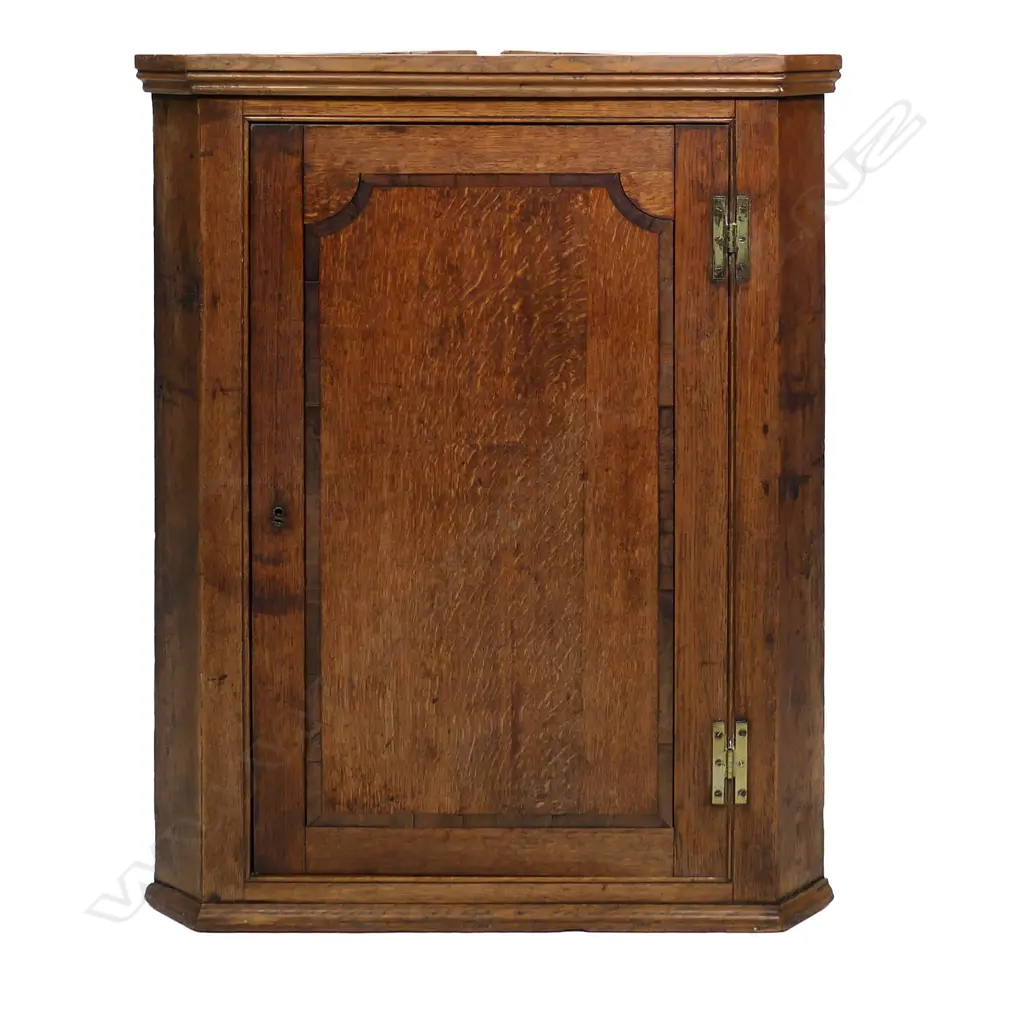 A late Georgian corner cabinet, inlaid panel to door, the interior with three scalloped shelves.  780 x 470 x 1065mm. Image 1++