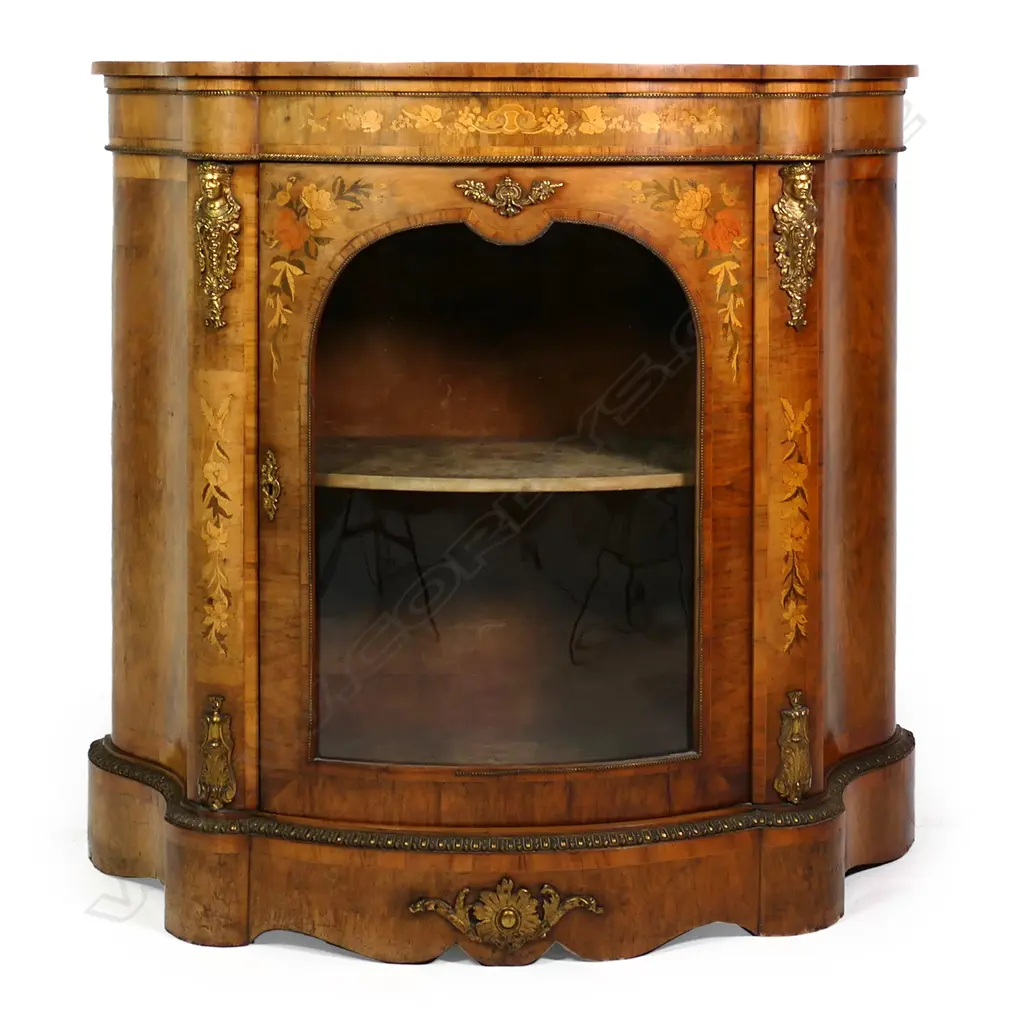 A Victorian walnut pier cabinet, curved sides, inlaid decoration and ormolu embellishments, two velvet lined shelves to the interior, slightly curved glass to the door, raised on plinth base.  1130 x 450 x 1170mm. Image 1++