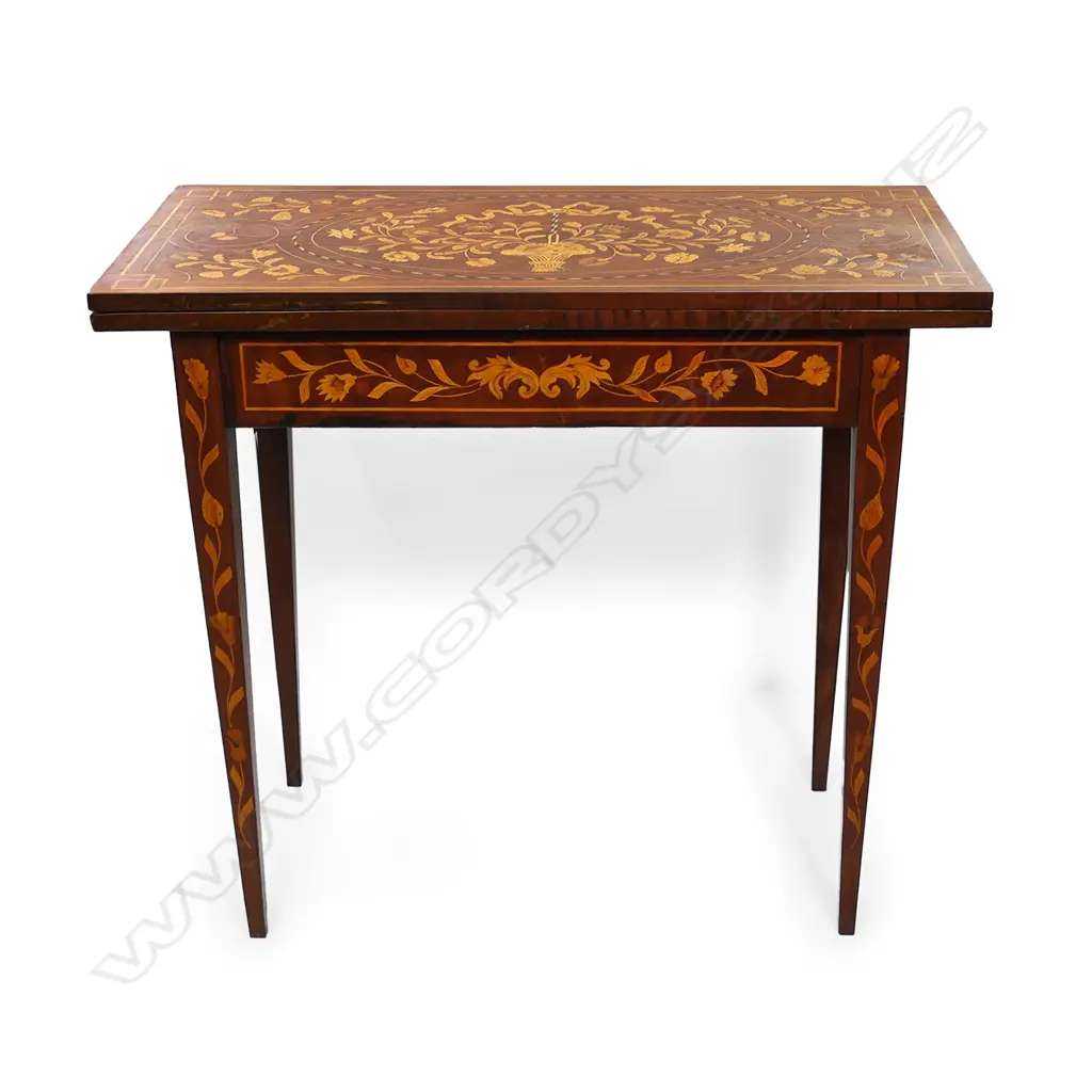 A 19thC Dutch marquetry card table, the top inlaid with flowers and a bow, the interior lined with black baize and inlaid with a suite of cards and more flowers, conforming inlaid decoration to the aprons and legs.  830 x 420 x 730mm. Image 1++