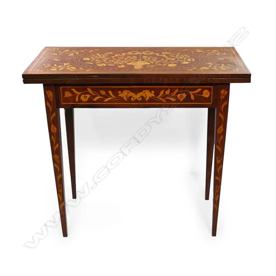 A 19thC Dutch marquetry card table, the top inlaid with flowers and a bow, the interior lined with black baize and inlaid with a suite of cards and more flowers, conforming inlaid decoration to the aprons and legs.  830 x 420 x 730mm.