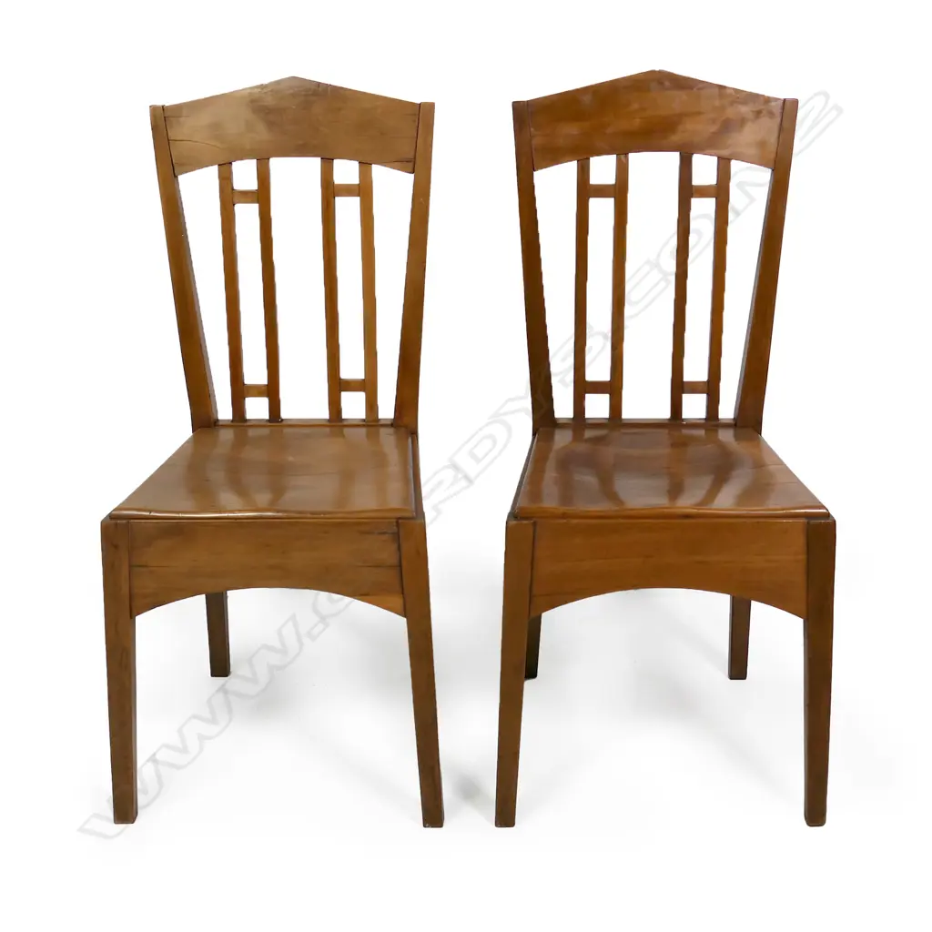 A pair of rimu Roy Lippincott lecture chairs, designed for the Old Arts/Clock Tower Building (1926) at 22 Princes St, Auckland which Lippincott also designed. Professional restoration to the seat of one chair. Image 1++