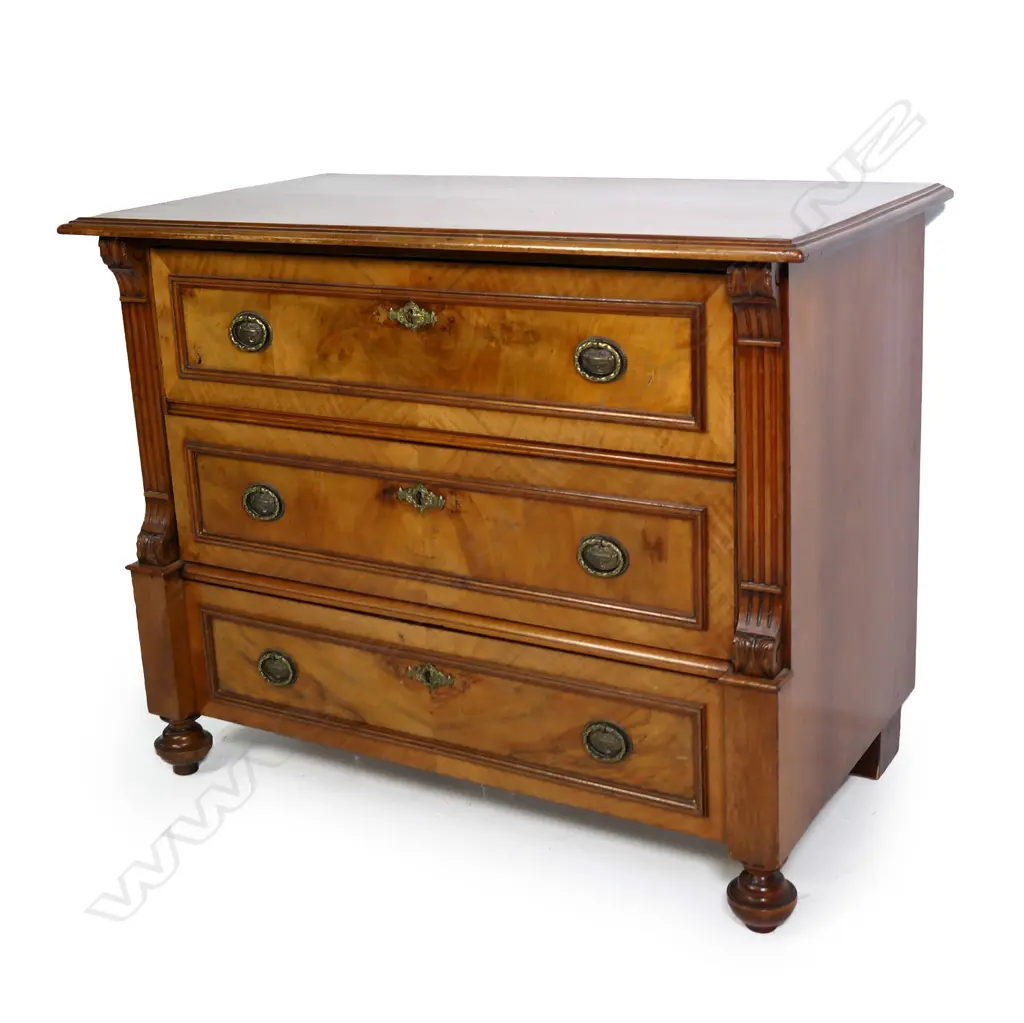 A Biedermeier style continental walnut chest of drawers, three full width drawers with carved sides, raised on turned feet.  990 x 530 x 770mm. Image 1++