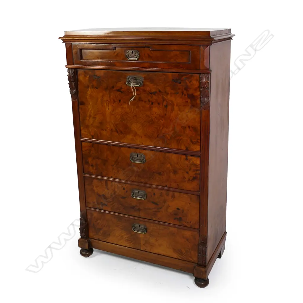 A Biedermeier walnut secrétaire à abattant, one frieze drawer above the fall front enclosing a fitted interior, three full width drawers below, carved corbels to each side top and bottom, raised on squat bun feet. 890 x 470 x 1430mm. Image 1++