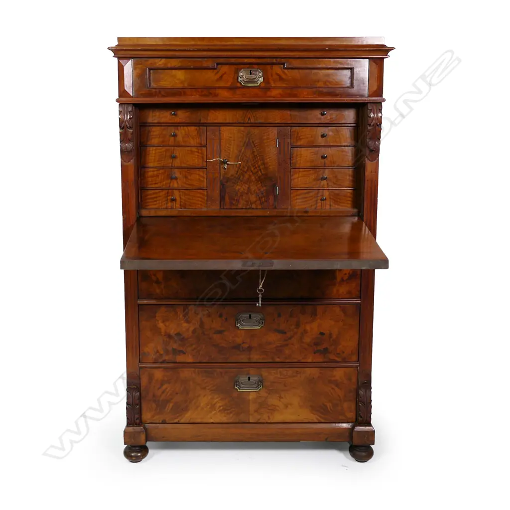 A Biedermeier walnut secrétaire à abattant, one frieze drawer above the fall front enclosing a fitted interior, three full width drawers below, carved corbels to each side top and bottom, raised on squat bun feet. 890 x 470 x 1430mm. Image 1++