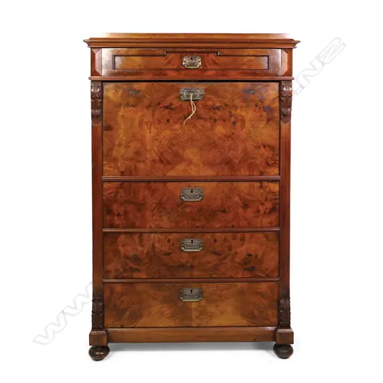 A Biedermeier walnut secrétaire à abattant, one frieze drawer above the fall front enclosing a fitted interior, three full width drawers below, carved corbels to each side top and bottom, raised on squat bun feet. 890 x 470 x 1430mm.