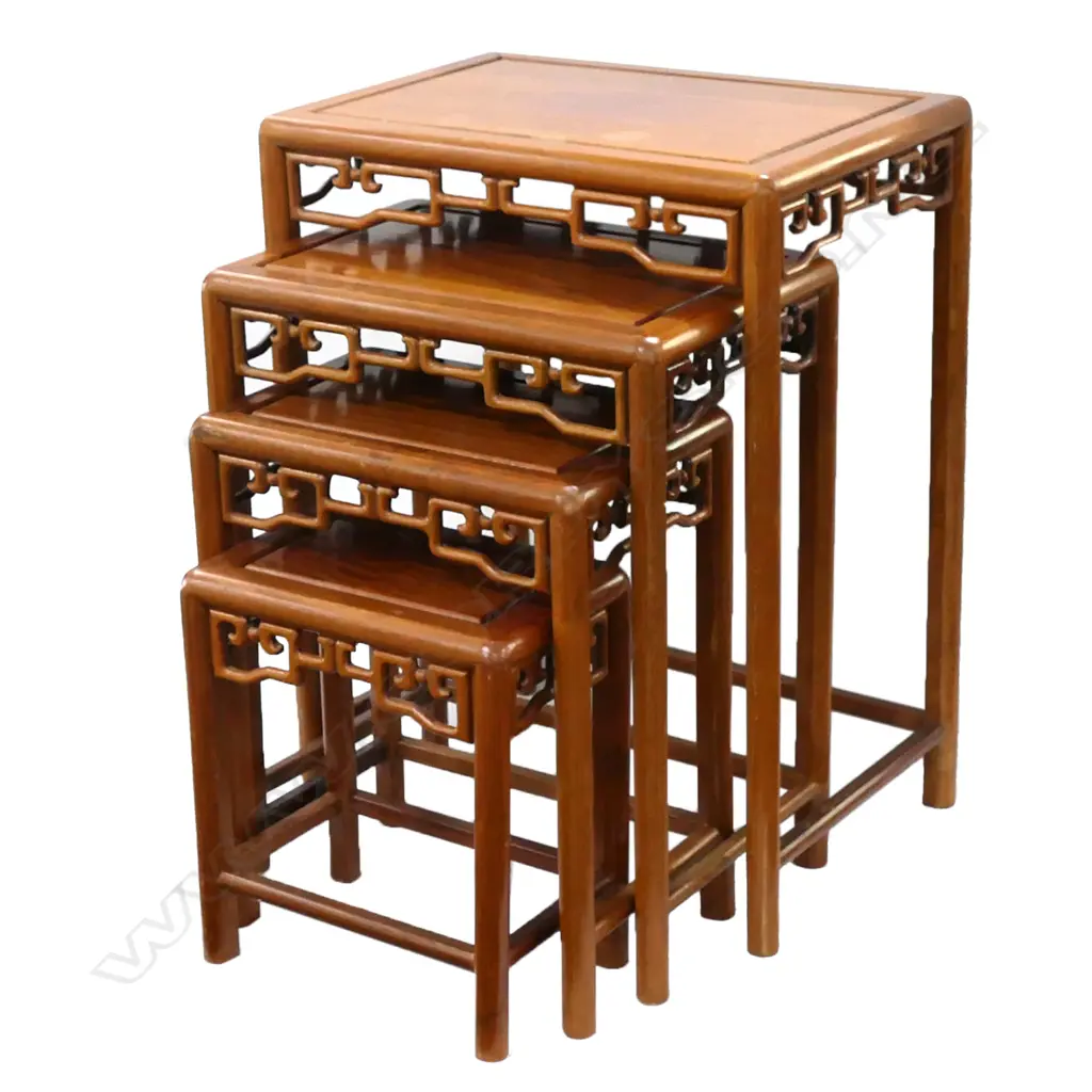 A Chinese rosewood nest of tables, the four stacking tables with decorative aprons.  500 x 350 x 660mm (largest). Image 1++