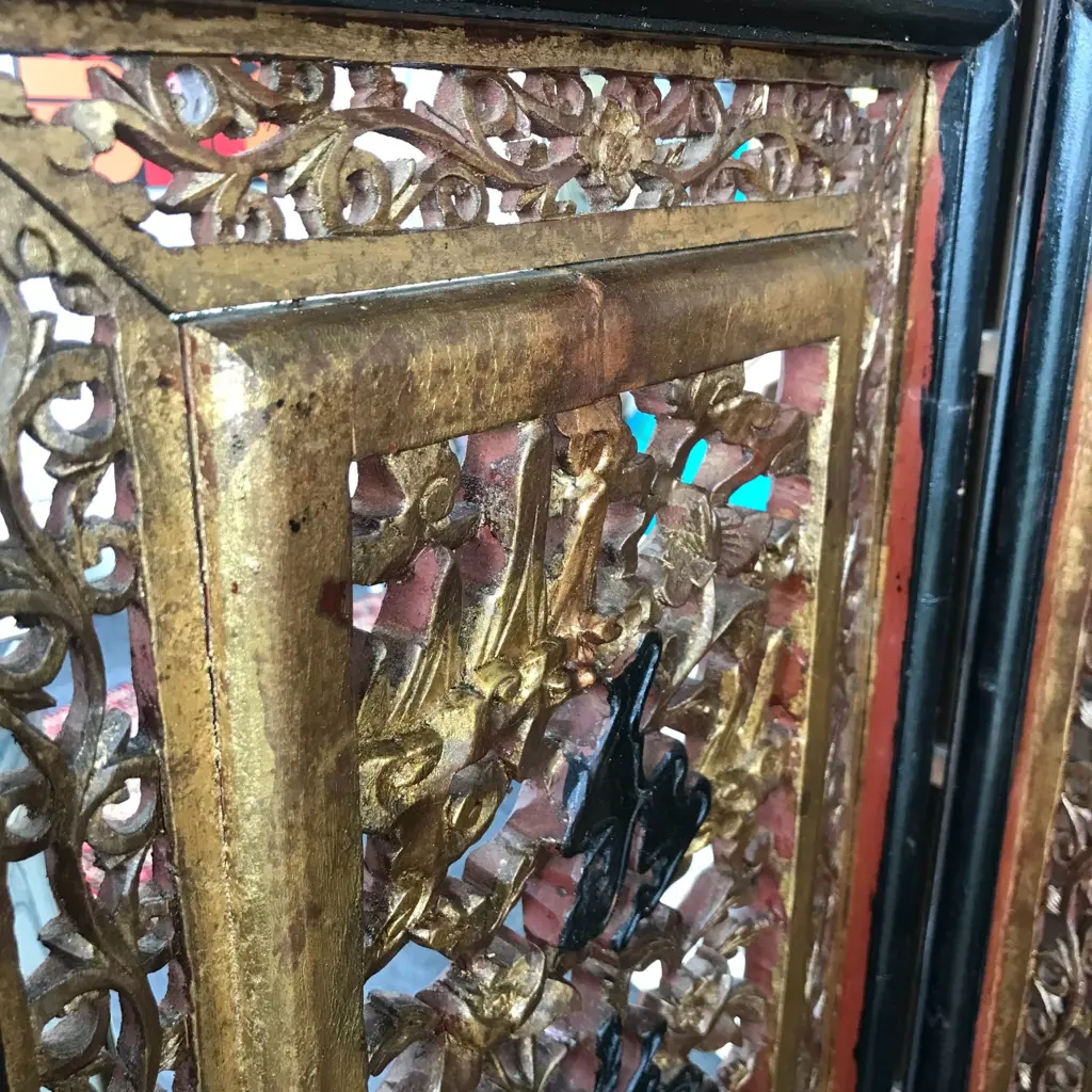 A 19thC six-fold Chinese screen, each panel with pierced decoration of calligraphy, birds and flowering branches, gilded with black and red paint finish, each panel measures 400 x 2050mm. Image 1++