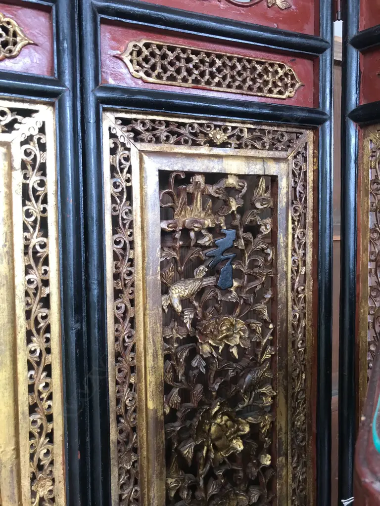 A 19thC six-fold Chinese screen, each panel with pierced decoration of calligraphy, birds and flowering branches, gilded with black and red paint finish, each panel measures 400 x 2050mm. Image 1++