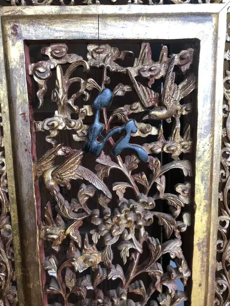 A 19thC six-fold Chinese screen, each panel with pierced decoration of calligraphy, birds and flowering branches, gilded with black and red paint finish, each panel measures 400 x 2050mm. Image 1++