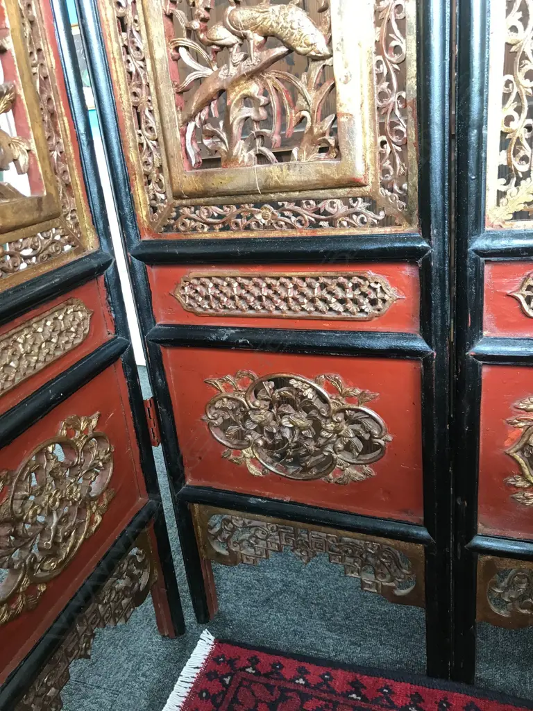 A 19thC six-fold Chinese screen, each panel with pierced decoration of calligraphy, birds and flowering branches, gilded with black and red paint finish, each panel measures 400 x 2050mm. Image 1++