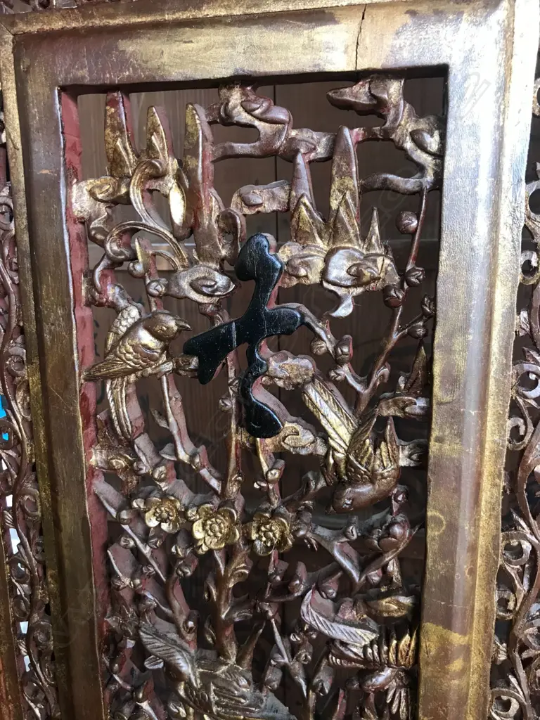 A 19thC six-fold Chinese screen, each panel with pierced decoration of calligraphy, birds and flowering branches, gilded with black and red paint finish, each panel measures 400 x 2050mm. Image 1++