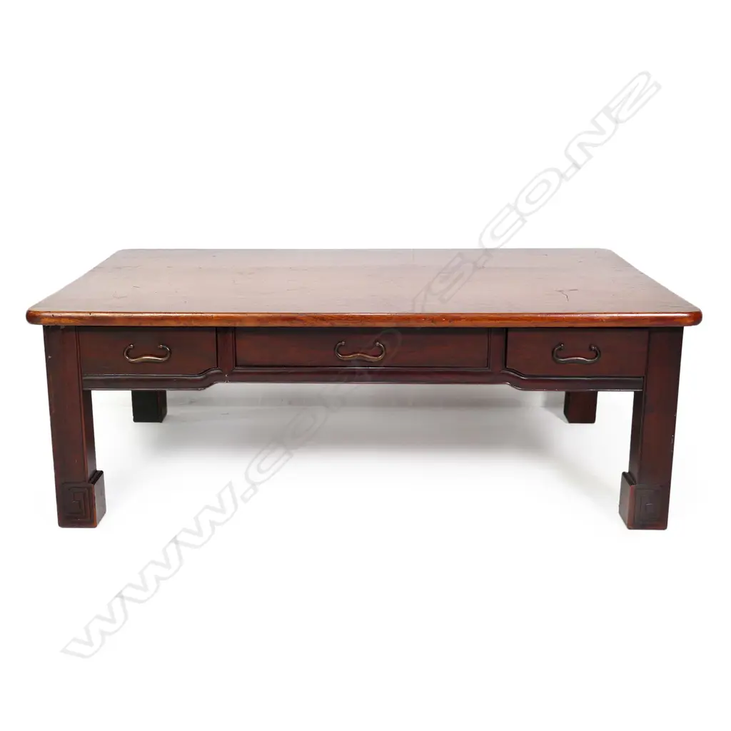 A vintage Oriental rosewood low table, plain rectangular form with three frieze drawers, raised on short square section legs with scroll feet. 880 x 540 x 310mm. Image 1++