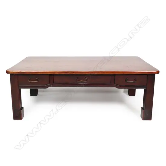 A vintage Oriental rosewood low table, plain rectangular form with three frieze drawers, raised on short square section legs with scroll feet. 880 x 540 x 310mm.