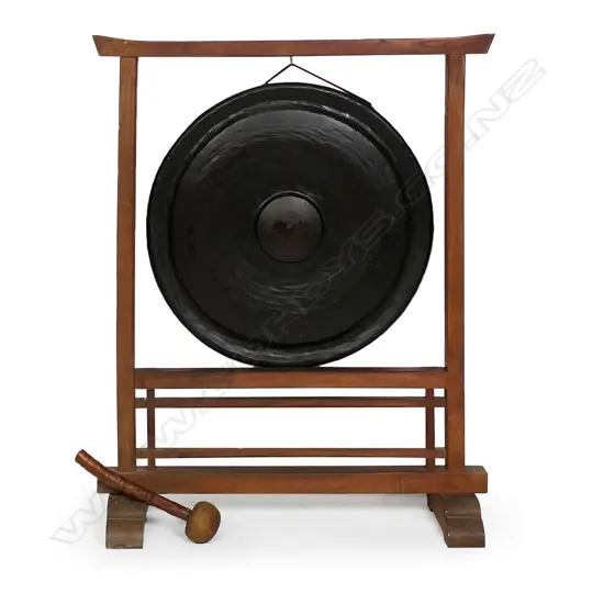 A large old Japanese bronze temple gong in wooden stand