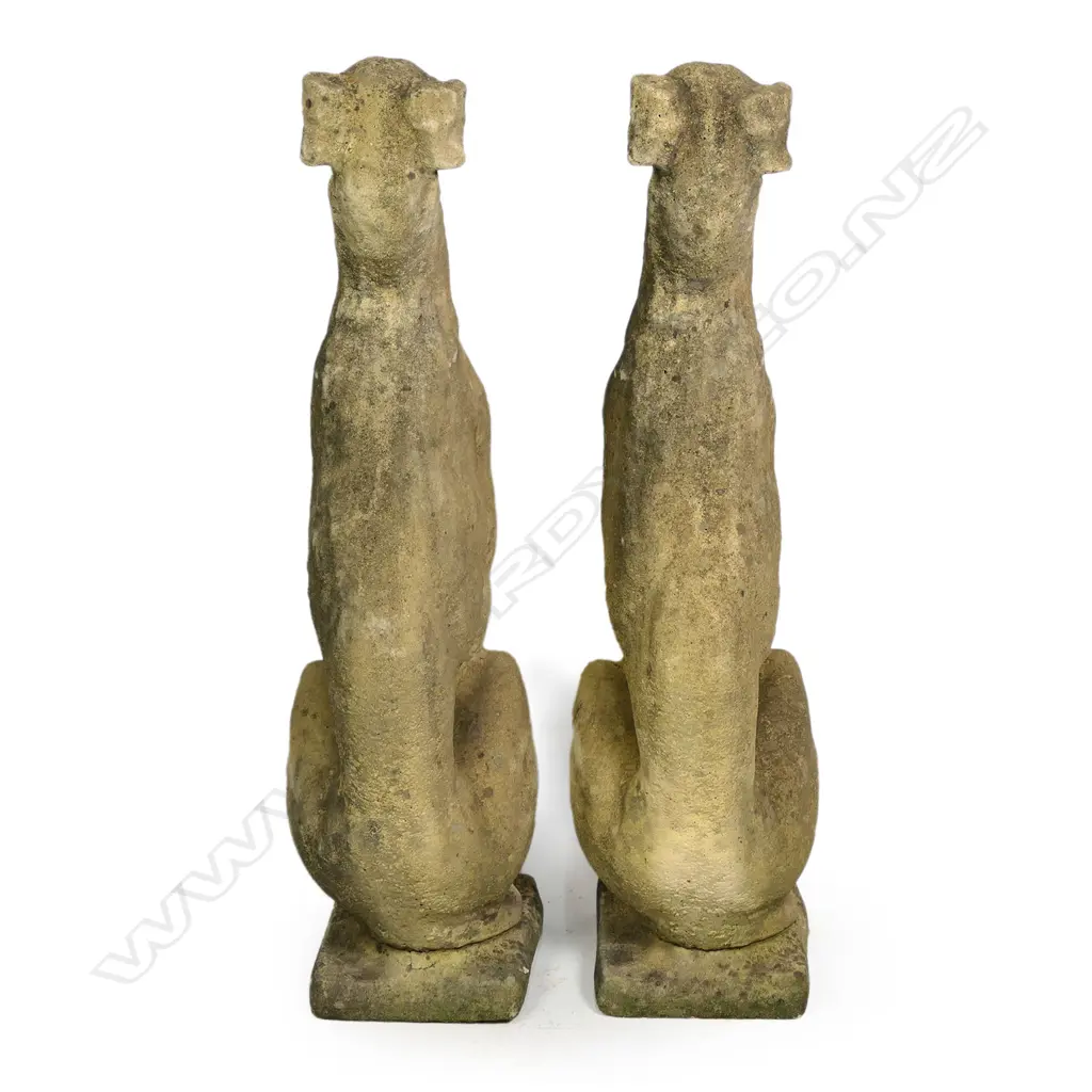 A pair of classical Church Stone greyhounds, in seated position, on small plinth base, weathered patina. H.750mm. Image 1++