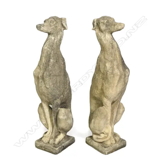 A pair of classical Church Stone greyhounds, in seated position, on small plinth base, weathered patina. H.750mm.