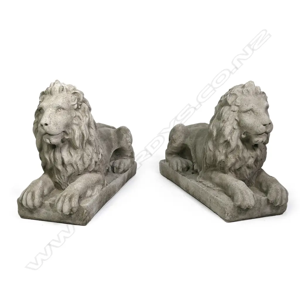 A pair of large classical recumbent concrete lions, each on rectangular plinth base. 800 x 290 x 530mm. After Sir Edwin Landseer famous sculptures of the four lions at the base of Nelson's Column in Trafalgar Square, London. Image 1++