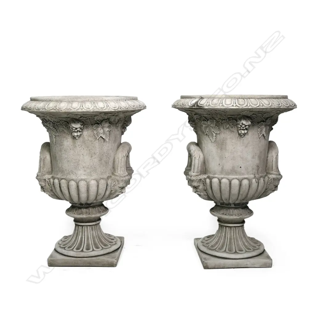 A pair of quality English made cast concrete classical garden urns, Regency style with ogee and dart flared top rims, grape leave and bunch detail below, the looping handles with mask supports. The lobed pedestals with square bases. Dia.530mm. H.710mm. Image 1++