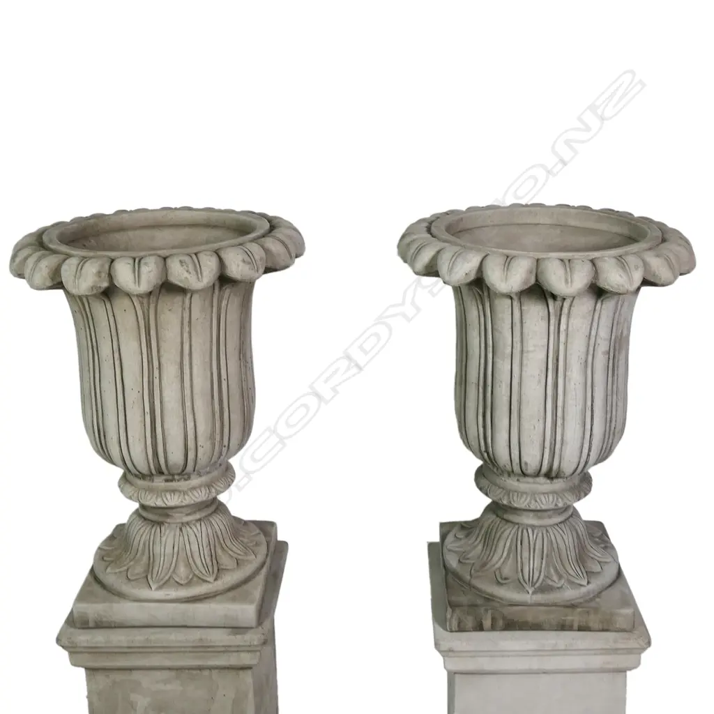 A pair of quality English made cast concrete classical garden urns raised on plinths, vertical fluted detail with swollen leafy flared top rims, the plinths of plain square form. H.1180mm. Image 1++