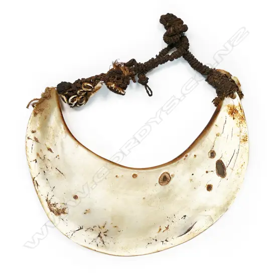 A breast ornament of mother of pearl shell (kina), Papua New Guinea,