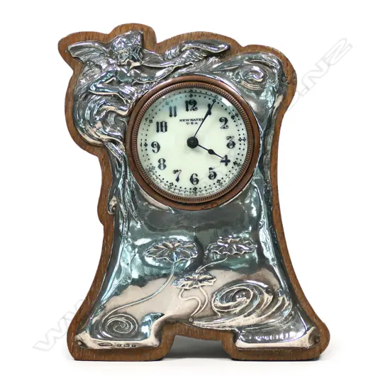 An Edwardian Art Nouveau silver and oak clock,