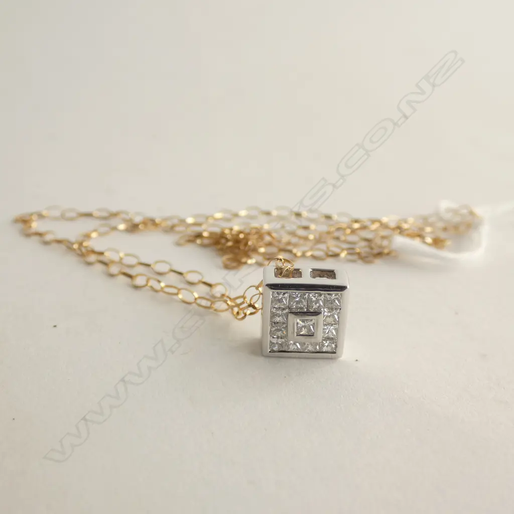 An 18ct white gold and diamond pendant Image 1++