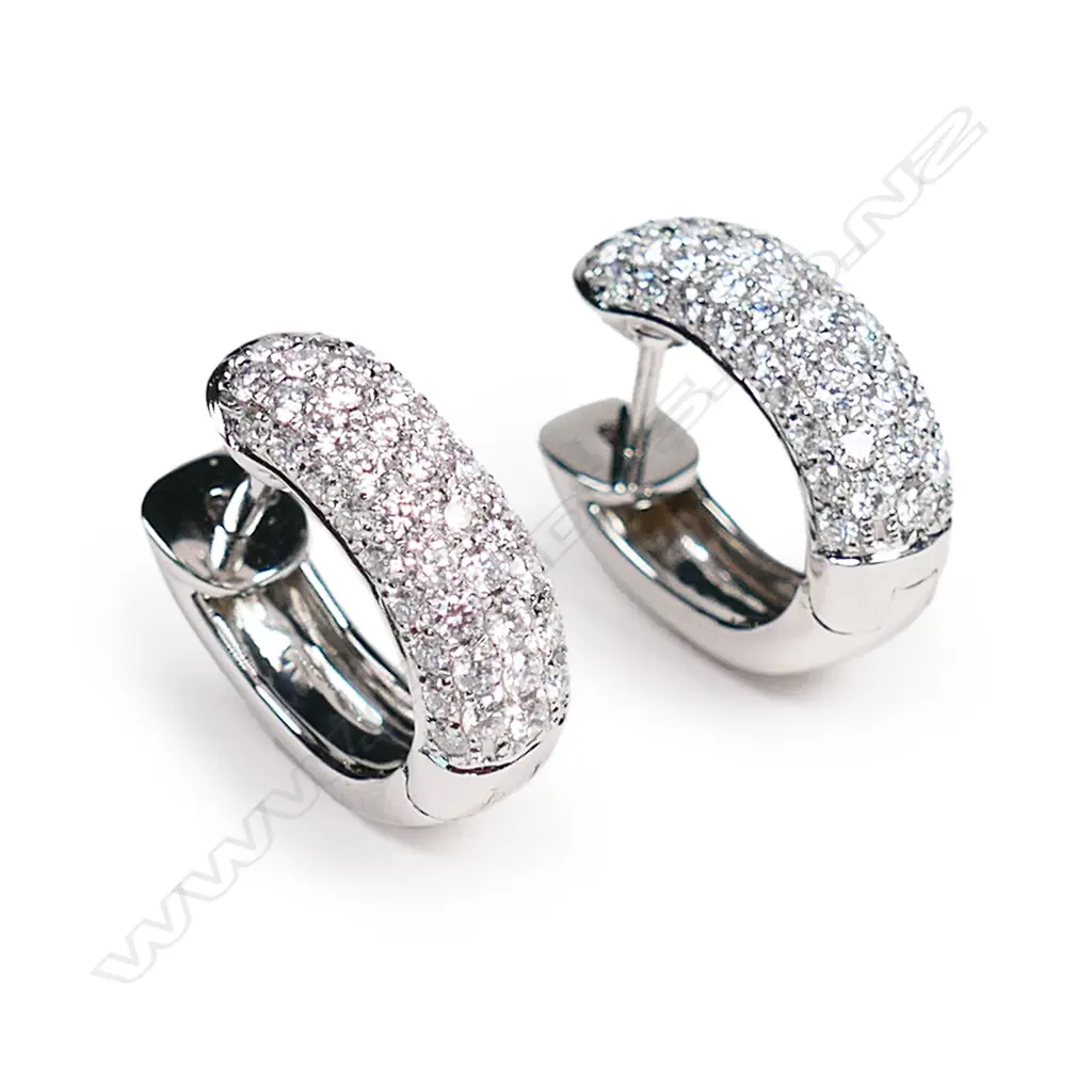 A pair of 18ct white gold and diamond huggie earrings, Image 1++