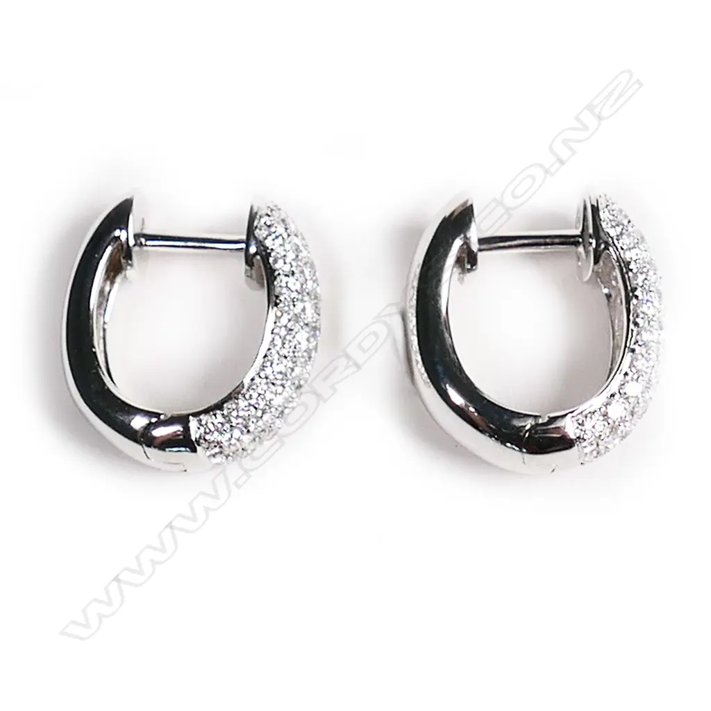 A pair of 18ct white gold and diamond huggie earrings, Image 1++