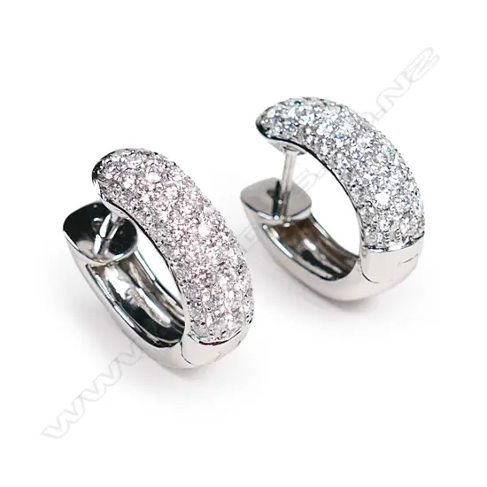 A pair of 18ct white gold and diamond huggie earrings,