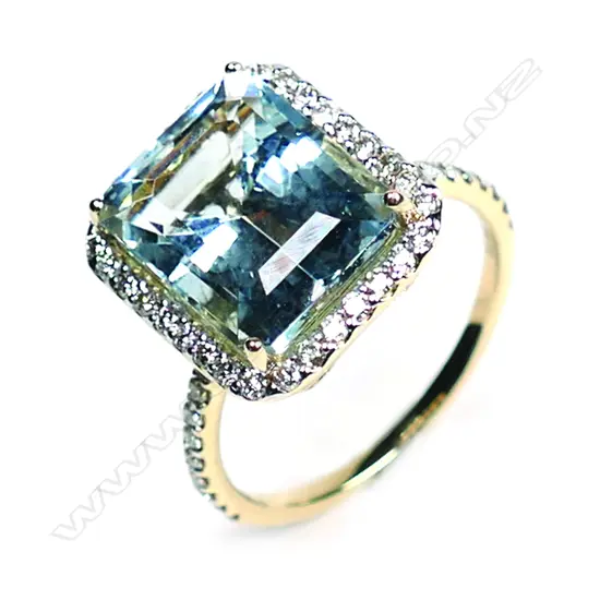 A 14ct. gold, aquamarine and diamond halo ring,