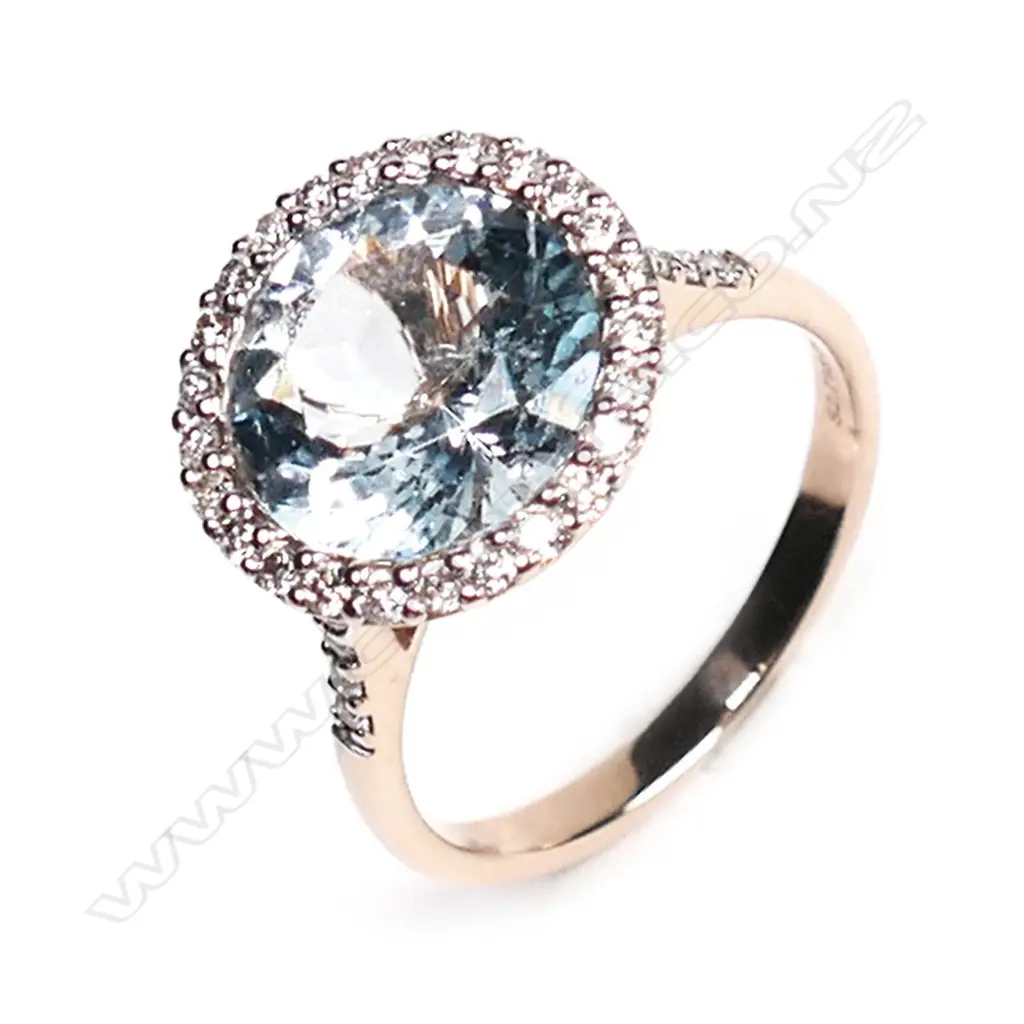 A 14ct rose gold, aquamarine and diamond halo ring, Image 1++