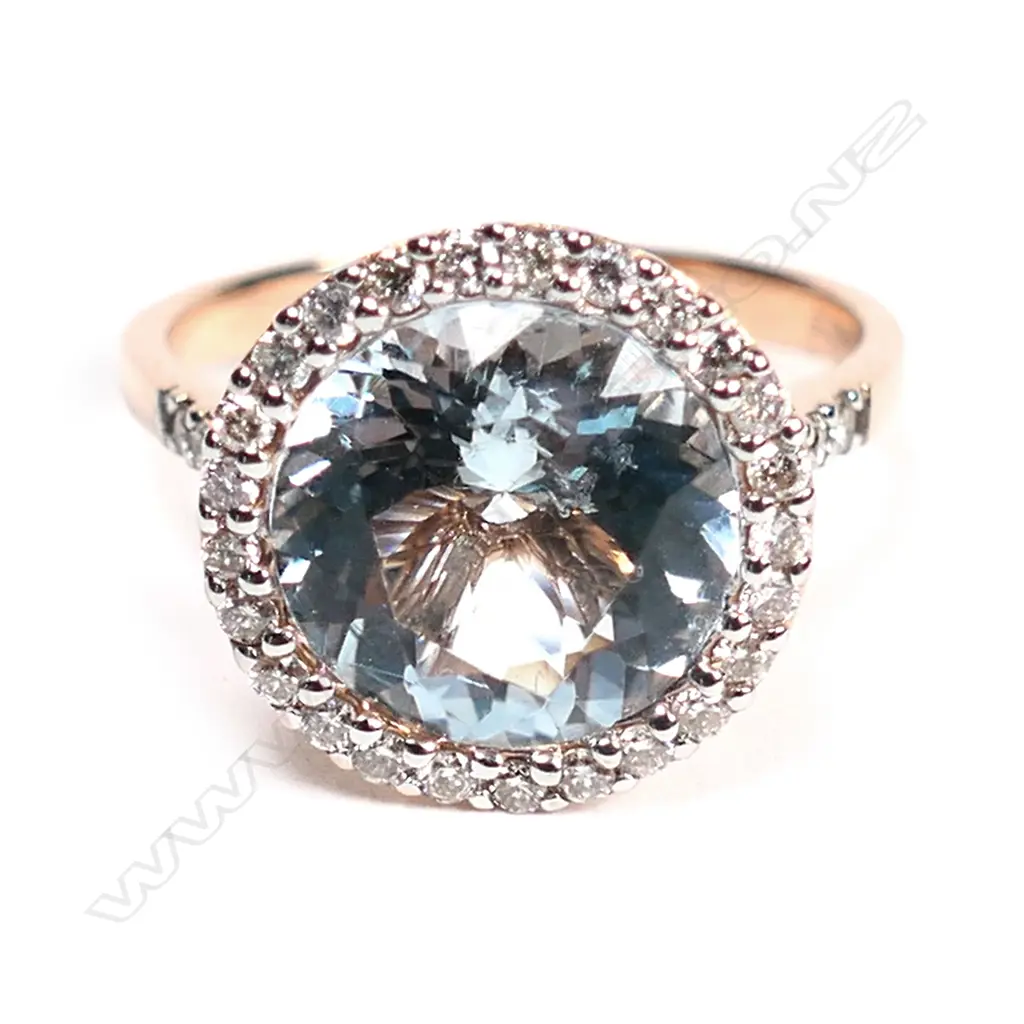 A 14ct rose gold, aquamarine and diamond halo ring, Image 1++