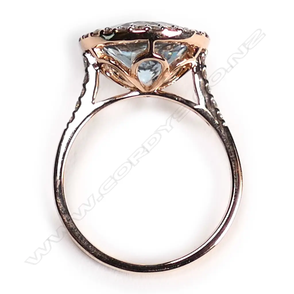A 14ct rose gold, aquamarine and diamond halo ring, Image 1++