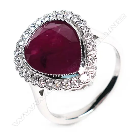 A 14ct white gold, ruby and diamond vintage style halo ring,
