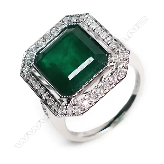 A 14ct white gold, emerald and diamond Art Deco style halo ring,