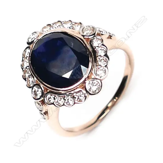 A 14ct rose gold, sapphire and diamond antique style halo ring,