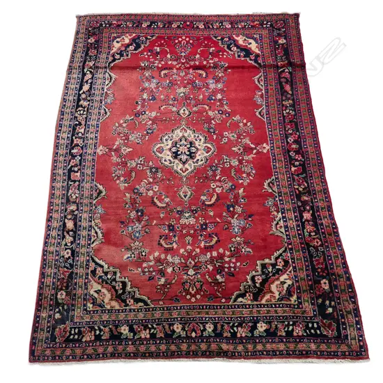 A large Persian hand knotted carpet,